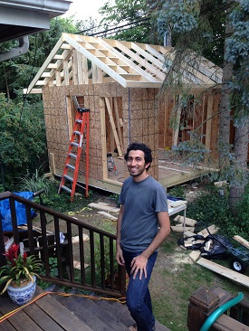person standing by cottage-in-progress